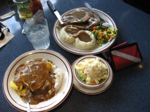 The bottom dish is a local favorite, Loco Moco - hamburger patty with two eggs on bed of rice covered with gravy