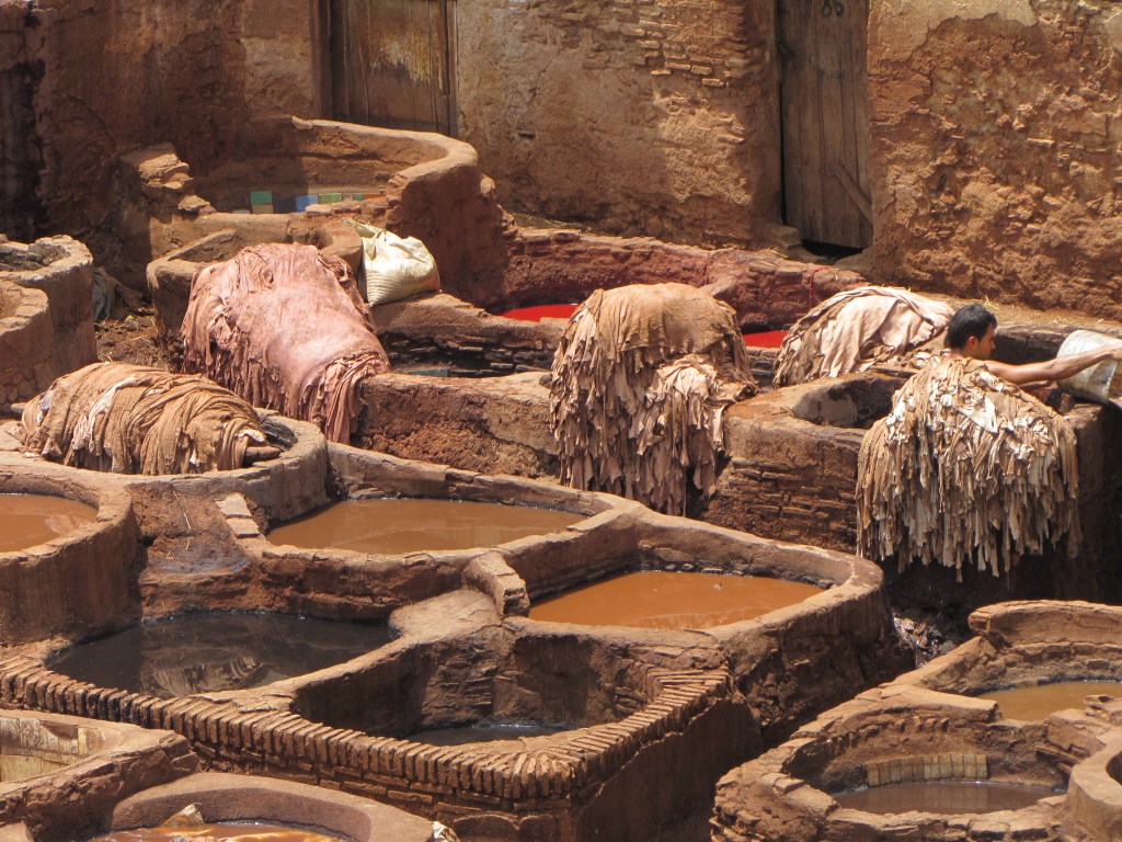 Man working at the tannery to make the leather soft enough to wear